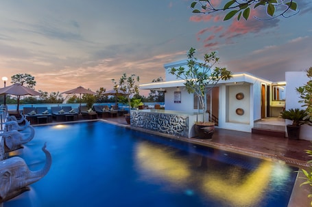 Outdoor pool, a rooftop pool, pool umbrellas, sun loungers