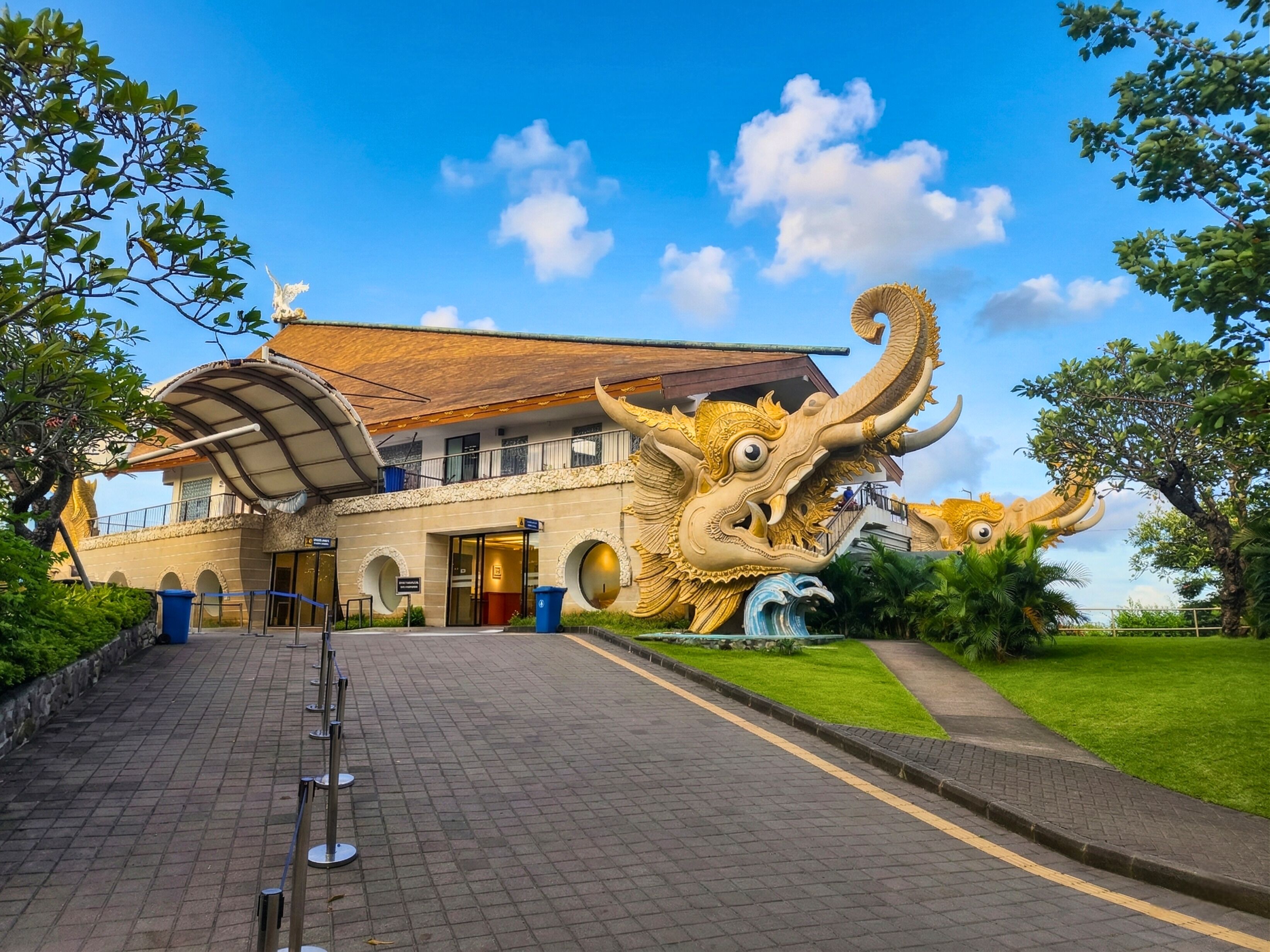 A building with a large dragon sculpture in front.