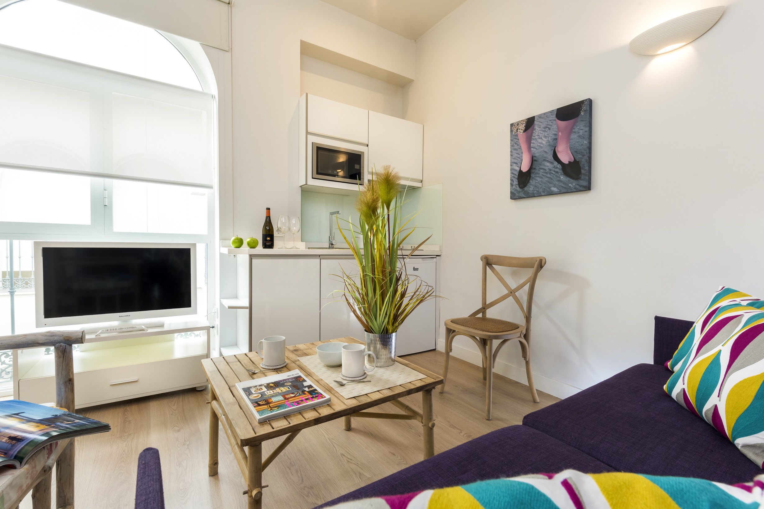 A modern apartment with a living room, a dining area, and a kitchen.