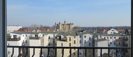 A view of a residential area with a prominent historical building in the background.