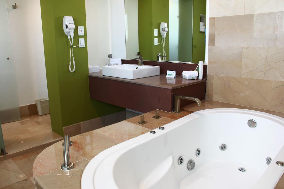 suite, 1 king bed | bathroom | separate bathtub and shower, hair dryer, towels