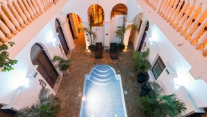 A spacious atrium with a central tiled area, multiple arches, and columns. - Masaya Santa Marta (Santa Marta)