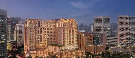 A high-rise building with multiple floors, surrounded by other tall buildings, and a well-lit urban environment.