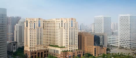 A high-rise building with a classical architectural style, surrounded by modern skyscrapers.