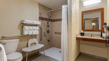 A bathroom with a shower, toilet, and sink.