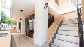 A covered walkway with a staircase leading to an upper level. - Chaba Garden Resort & Service (Pattaya)