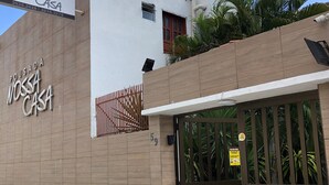 A building with a sign reading "Pousada Nossa Casa" and a gated entrance. - Pousada Nossa Casa (Maceió)