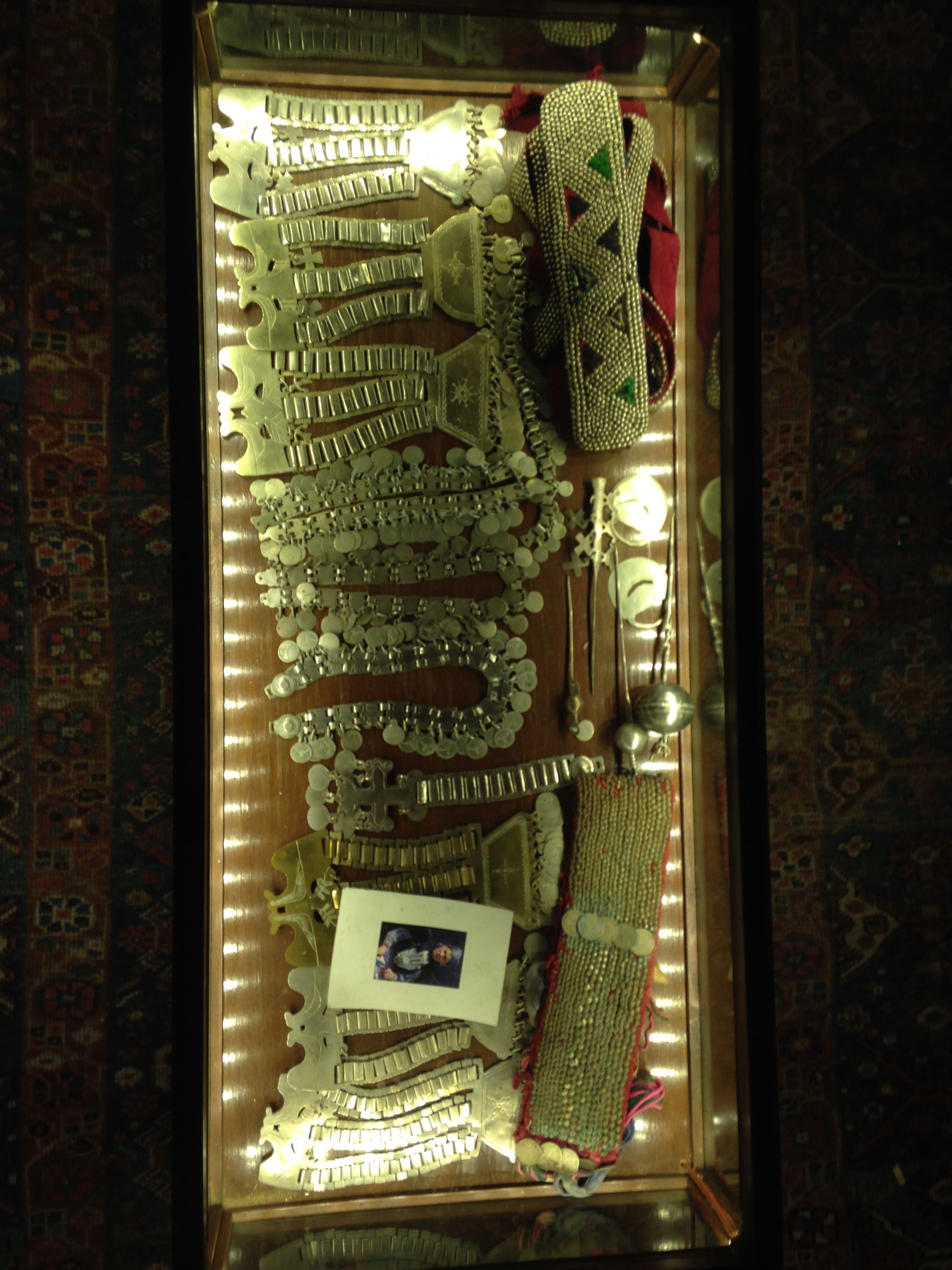 A display of various jewelry items, including necklaces, bracelets, and earrings, arranged on a wooden surface.