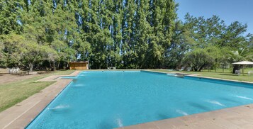 Una piscina al aire libre, tumbonas