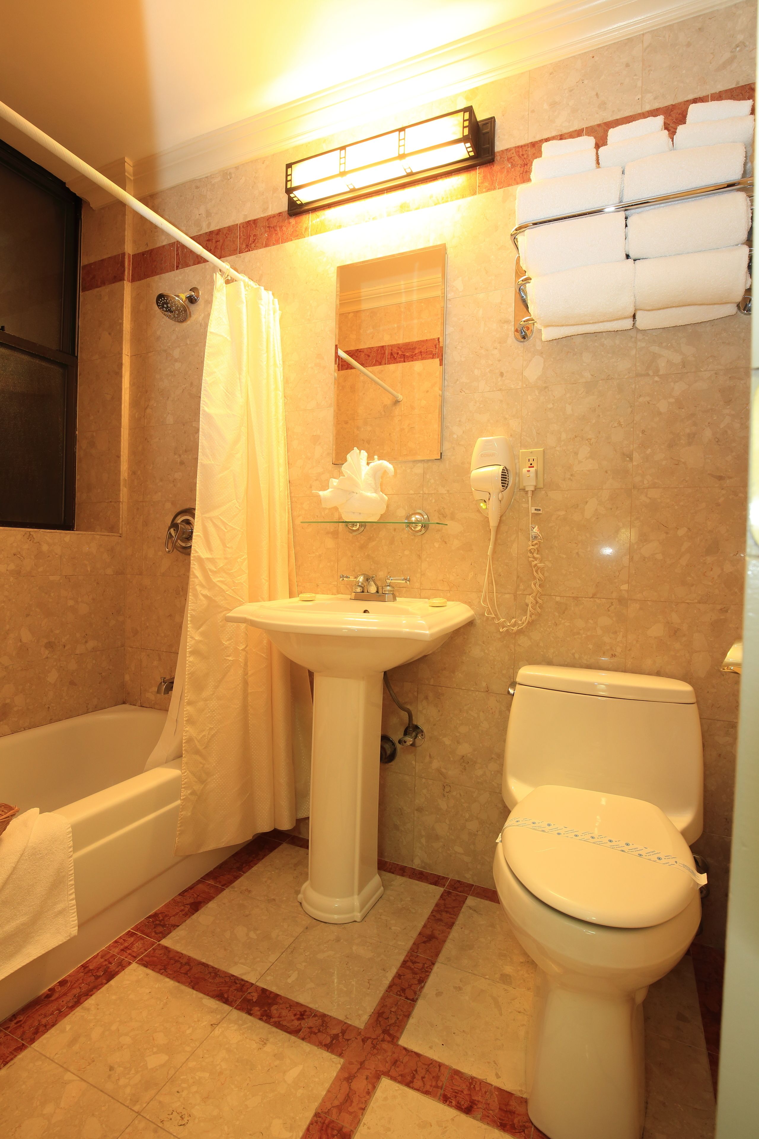 A bathroom with a bathtub, sink, and toilet.