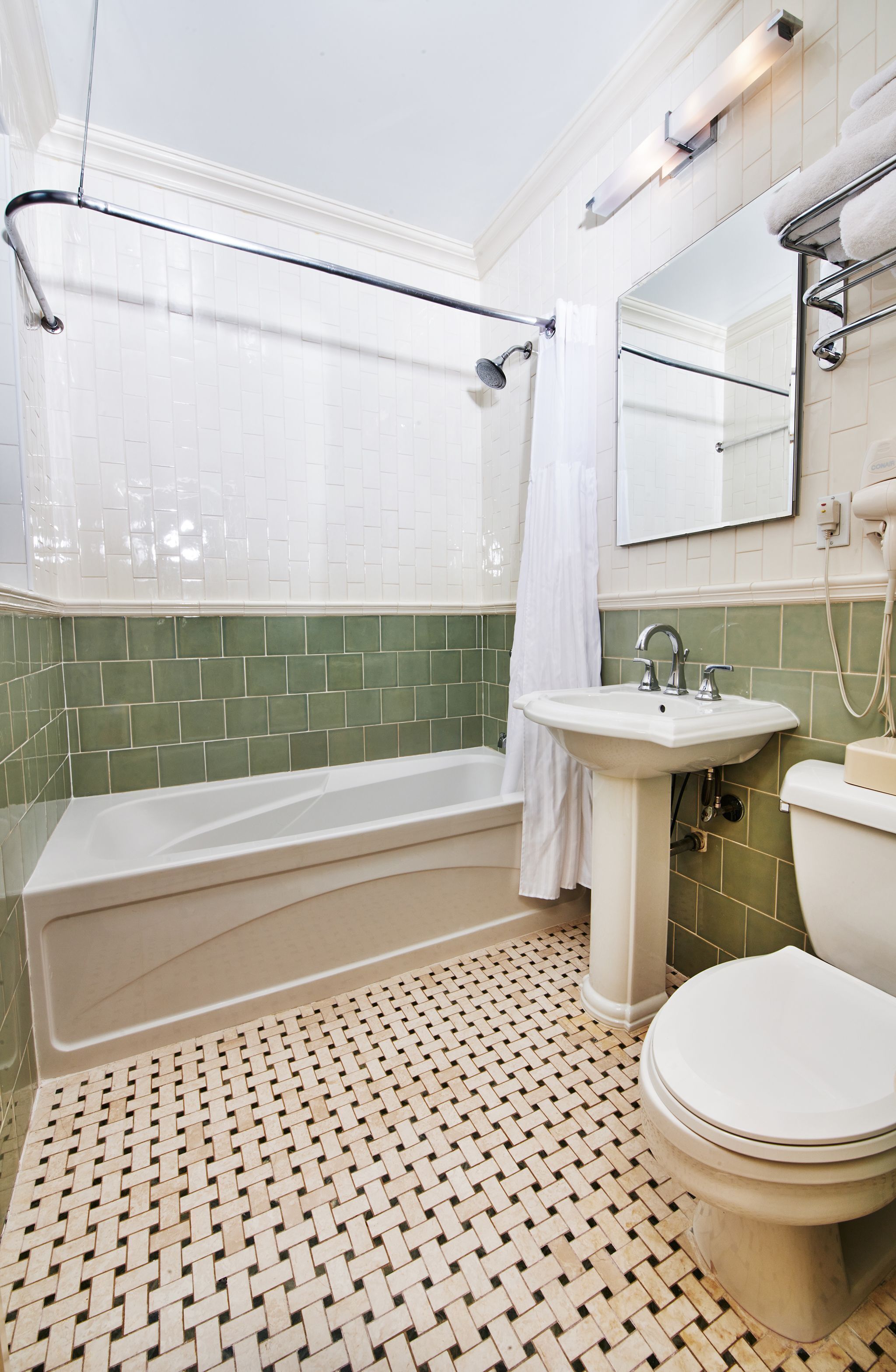 Une salle de bain équipée d’une baignoire, d’un lavabo, de toilettes et d’un rideau de douche.
