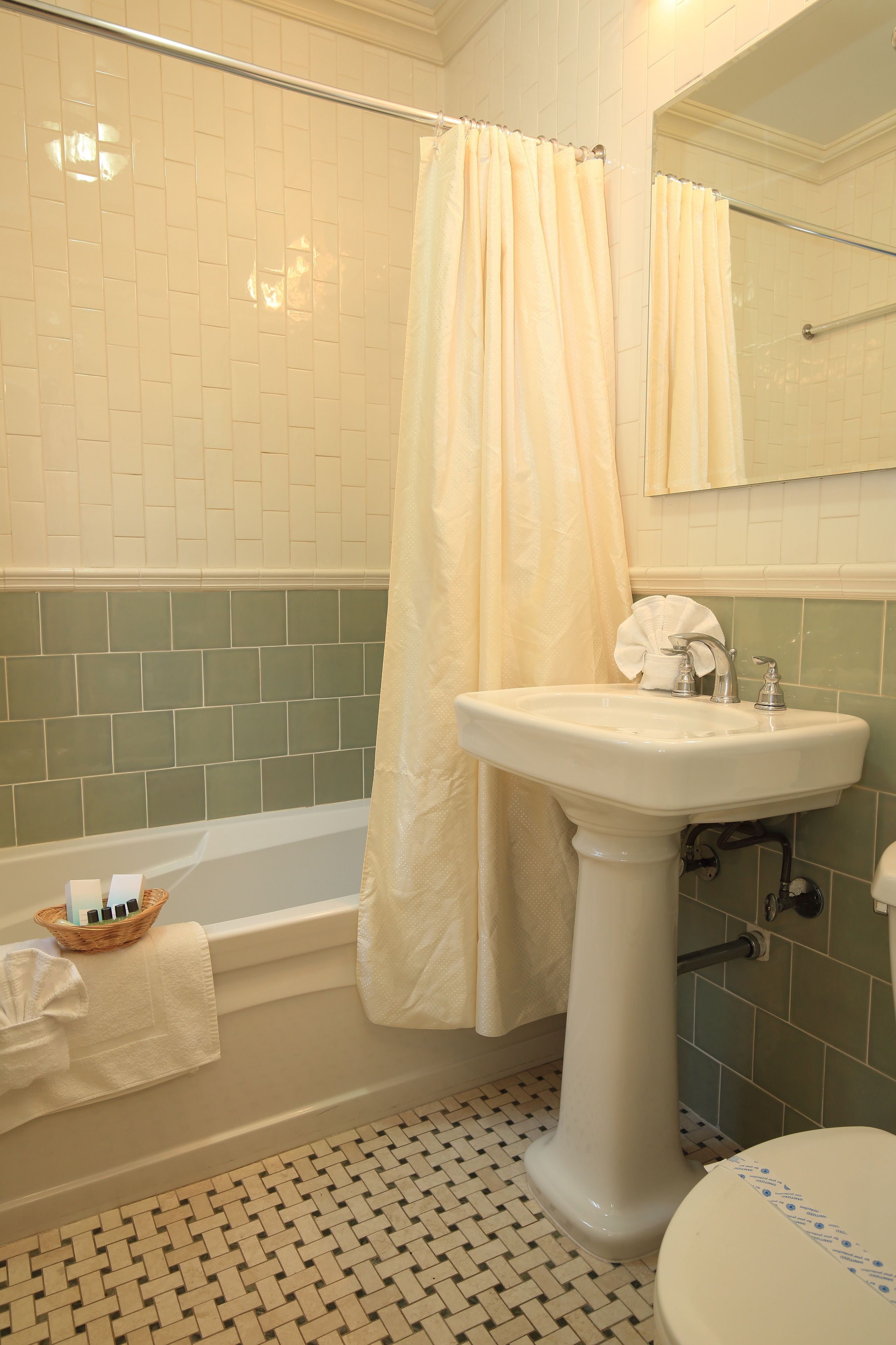 A bathroom with a bathtub, a sink, and a toilet.