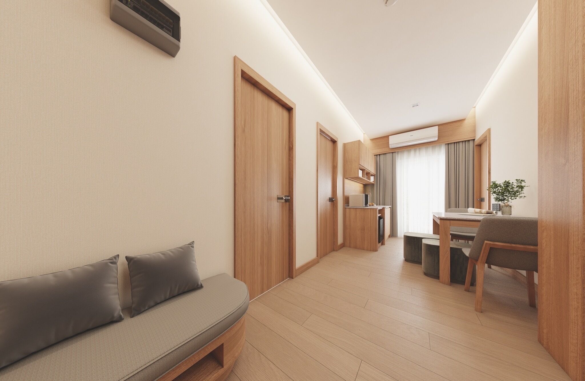 A modern hotel room with a wooden floor, a sofa, a dining area, and a kitchen.