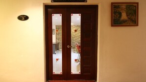 A hotel entrance with a wooden door, a sign above reading "DEWAN TUN TEJA", and a "LEVEL 3" sign on the wall. - AG Hotel Penang (George Town)