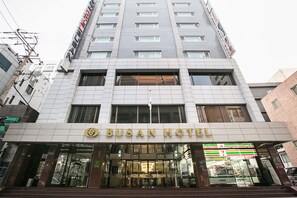 A hotel with a modern facade, large windows, and a visible T-Mobile store on the ground floor. - Busan Tourist Hotel (Busan)