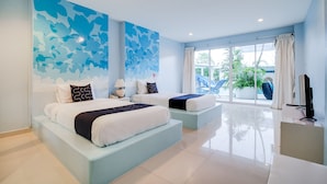 A modern hotel room with two beds, a large window, and a TV.