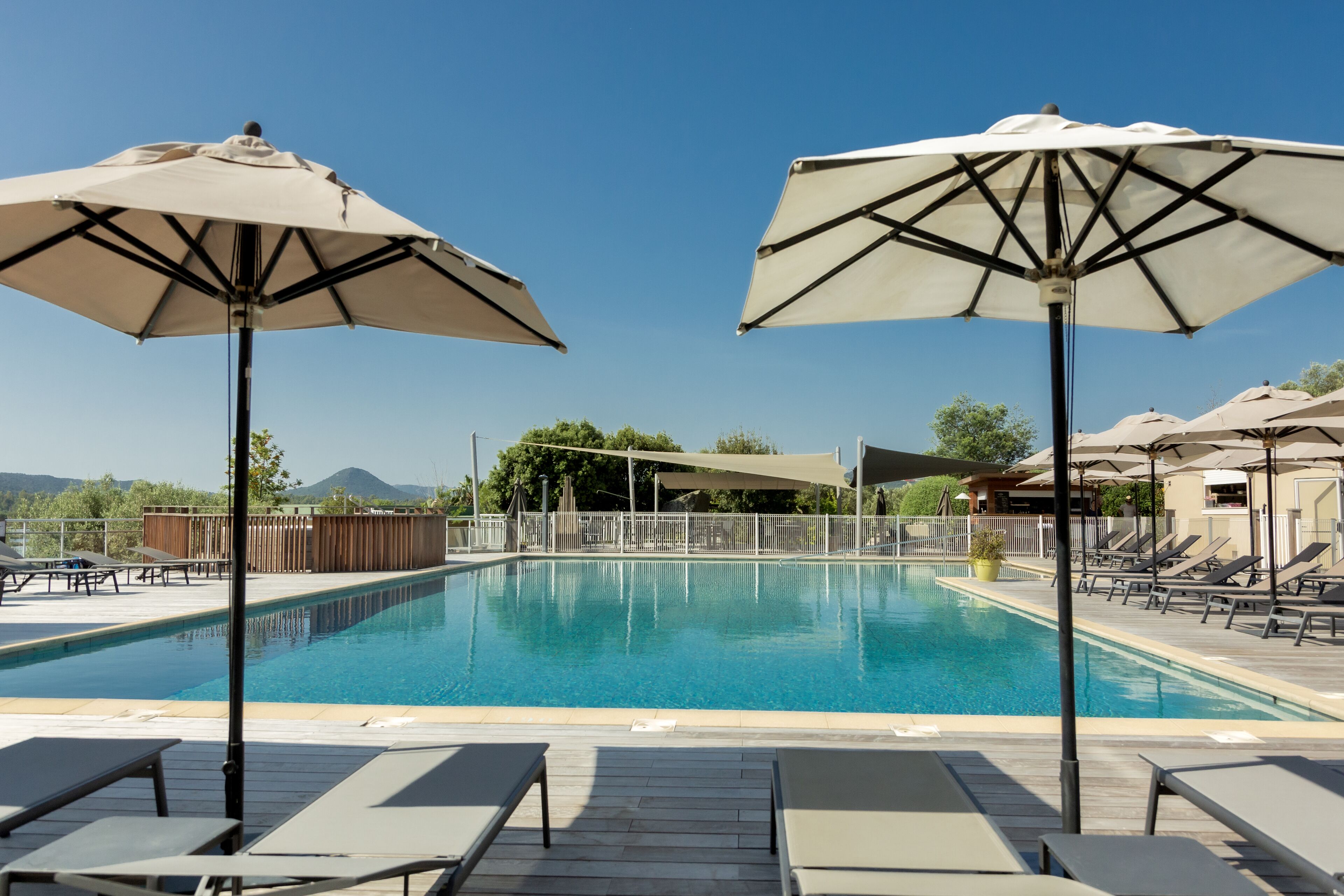 seasonal outdoor pool, pool umbrellas, pool loungers