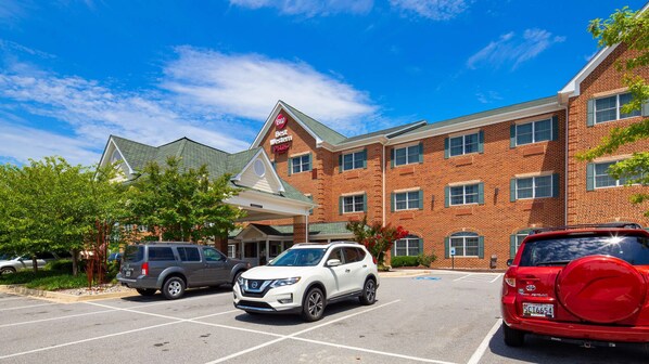 A hotel with a brick facade, a Best Western Plus sign, and a parking lot with several SUVs. - Best Western Plus Easton Inn & Suites (Easton)