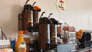 A breakfast bar with coffee makers, a juice dispenser, and a sign for 'Superstart Breakfast'. - Super 8 by Wyndham Rahway/Newark (Rahway)