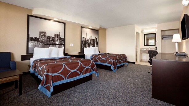 A hotel room with two beds, a desk, a chair, and a television. - Super 8 by Wyndham Rahway/Newark (Rahway)