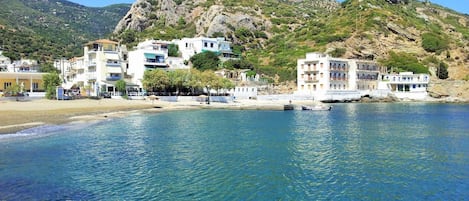 Una playa cerca, sillas reclinables de playa, sombrillas