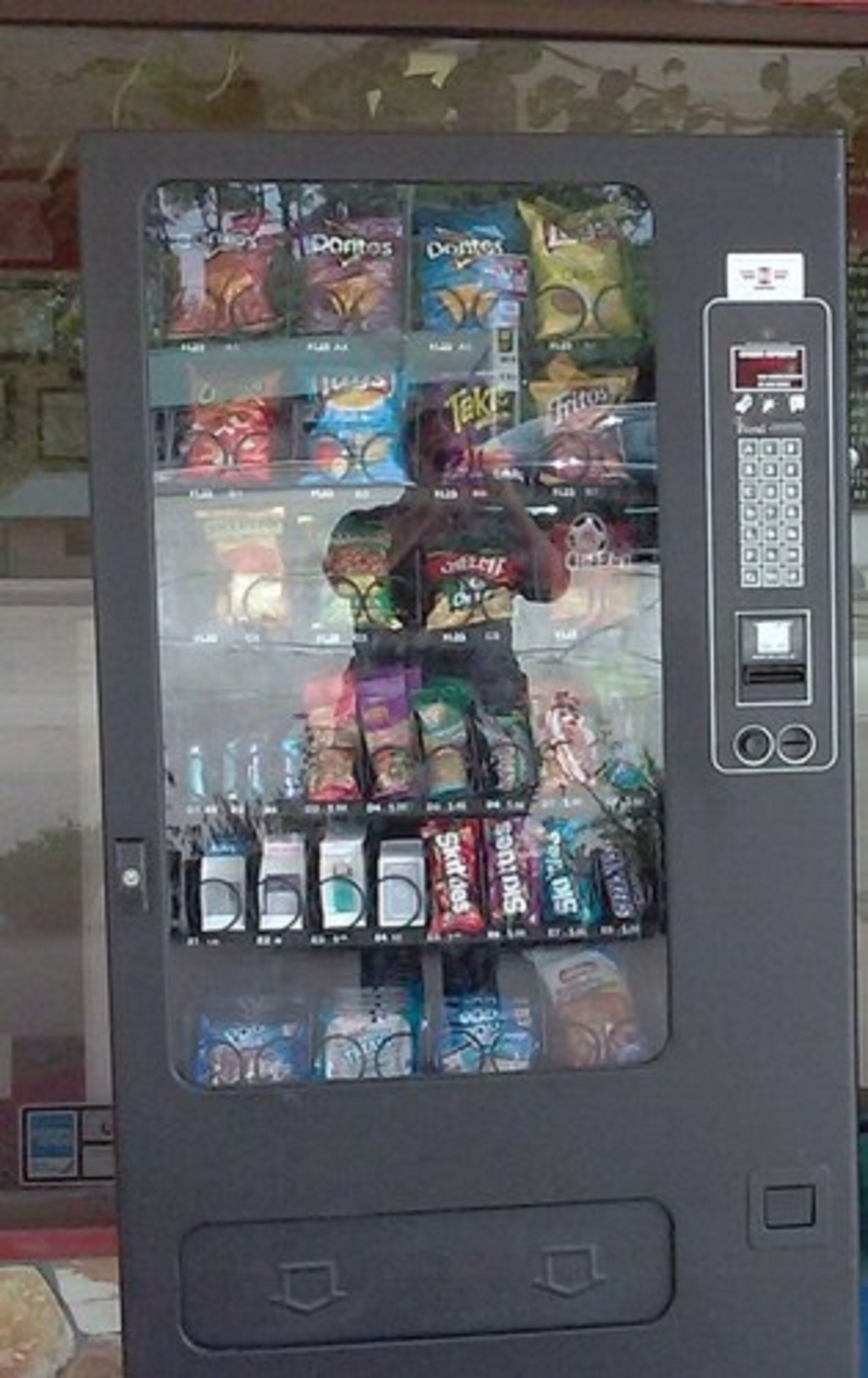 A vending machine with various snacks and drinks.
