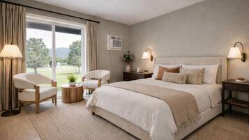 A bedroom with a large bed, two bedside tables, a chair, a round wooden table, and a view of a green landscape through a window.