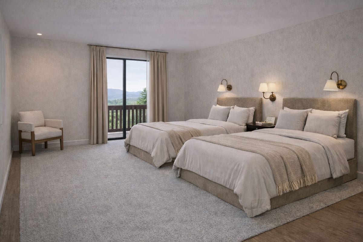 A bedroom with two beds, a chair, a nightstand, and a view of the outdoors.
