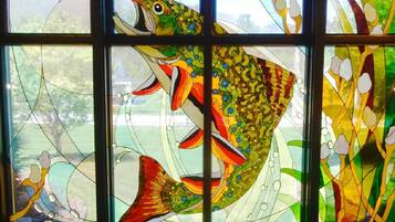 A stained glass window with a large fish design.