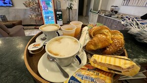 A breakfast tray with croissants, a muffin, and a packet of Nutella. - Hotel Clinton (Casoria)