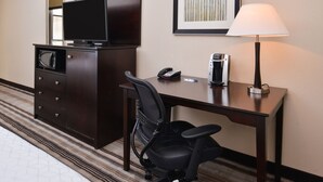 A hotel room with a desk, a chair, a television, a lamp, a phone, and a microwave. - Holiday Inn Express & Suites Emporia Northwest by IHG (Emporia)