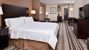 A hotel room with a large bed, a desk, a chair, a TV, and a dresser. - Holiday Inn Express & Suites Emporia Northwest by IHG (Emporia)