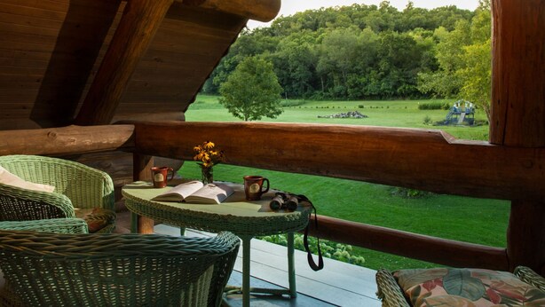 A cozy wooden cabin with a balcony overlooking a lush green landscape. - Justin Trails Resort, LLC. (Sparta)