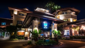 A modern hotel with a prominent 'Mind Resort' sign, featuring a well-lit entrance and lush landscaping. - Mind Resort Pattaya (Pattaya)