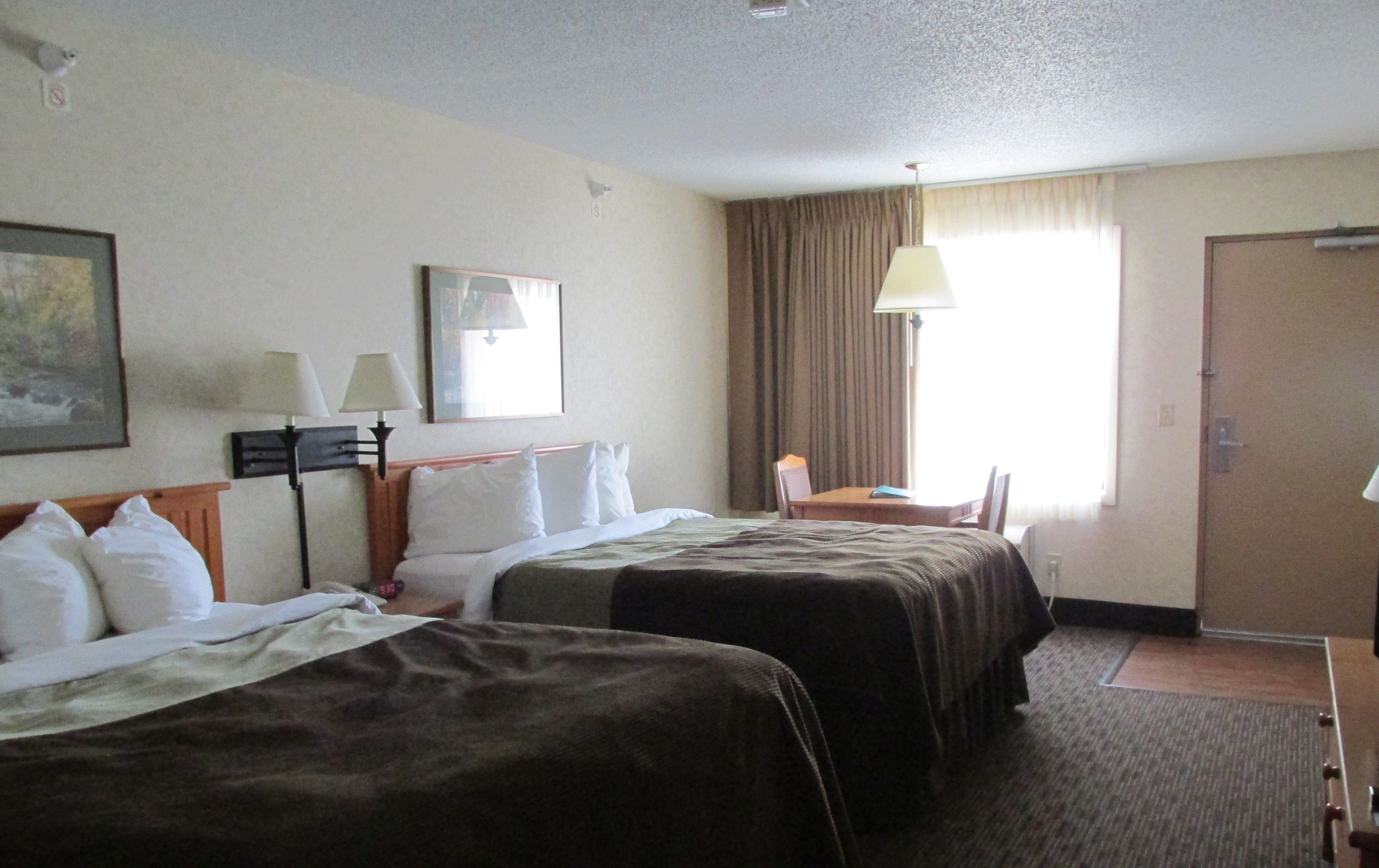 standard room, 2 queen beds (two queen beds main floor) | in-room safe, iron/ironing board, free wifi, bed sheets