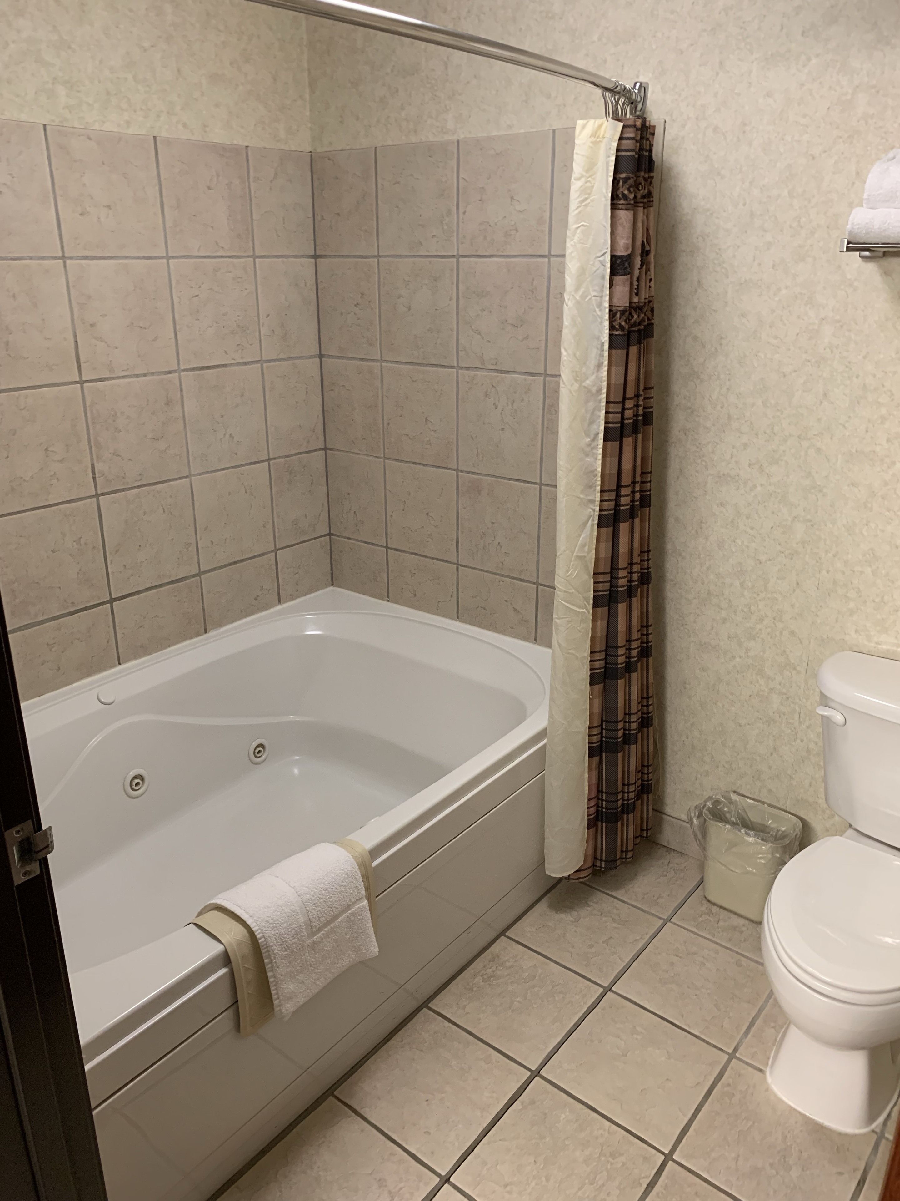 suite, 1 king bed with sofa bed, jetted tub (king suites main floor - jetted tub) | bathroom | combined shower/bathtub, free toiletries, hair dryer, towels