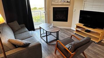 Deluxe Suite, 2 Bedrooms, Ocean View, Oceanfront | Living area | 50-inch flat-screen TV with cable channels, TV, fireplace