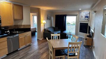Deluxe Suite, 2 Bedrooms, Ocean View, Oceanfront | Living area | 50-inch flat-screen TV with cable channels, TV, fireplace