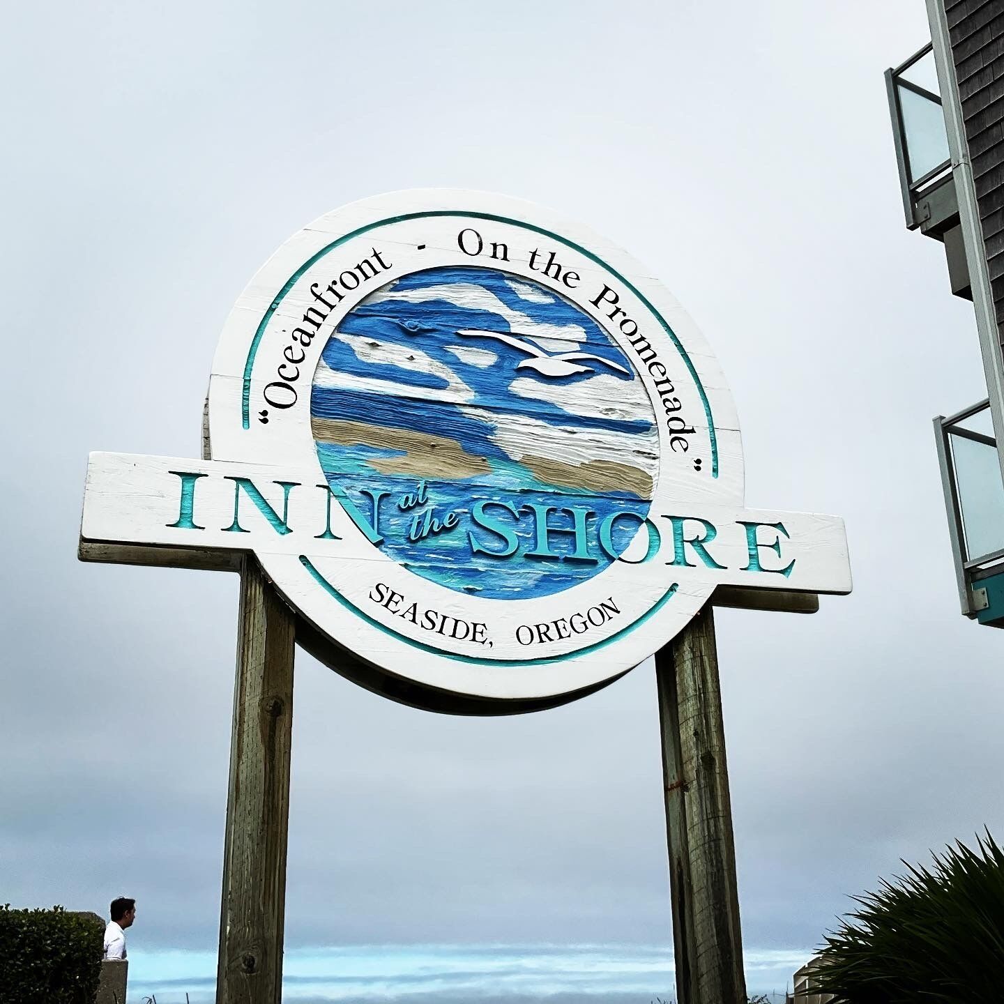 A circular sign with the text "INN at the Shore" and "Seaside, Oregon" indicating a coastal location.