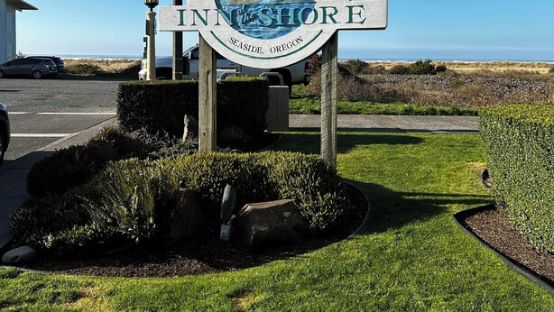 A sign with the text "INN the SHORE" and "Seaside, Oregon" indicating a location. - Inn at the Shore (Seaside)