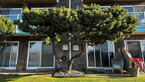 A two-story building with a balcony on the upper floor. - Inn at the Shore (Seaside)