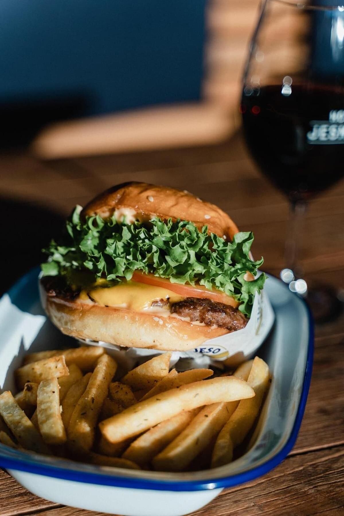 A burger with fries on a table.