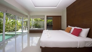 A modern bedroom with a large bed, a glass-enclosed patio, and a view of greenery. - The Living Pool Villas (Koh Samui)