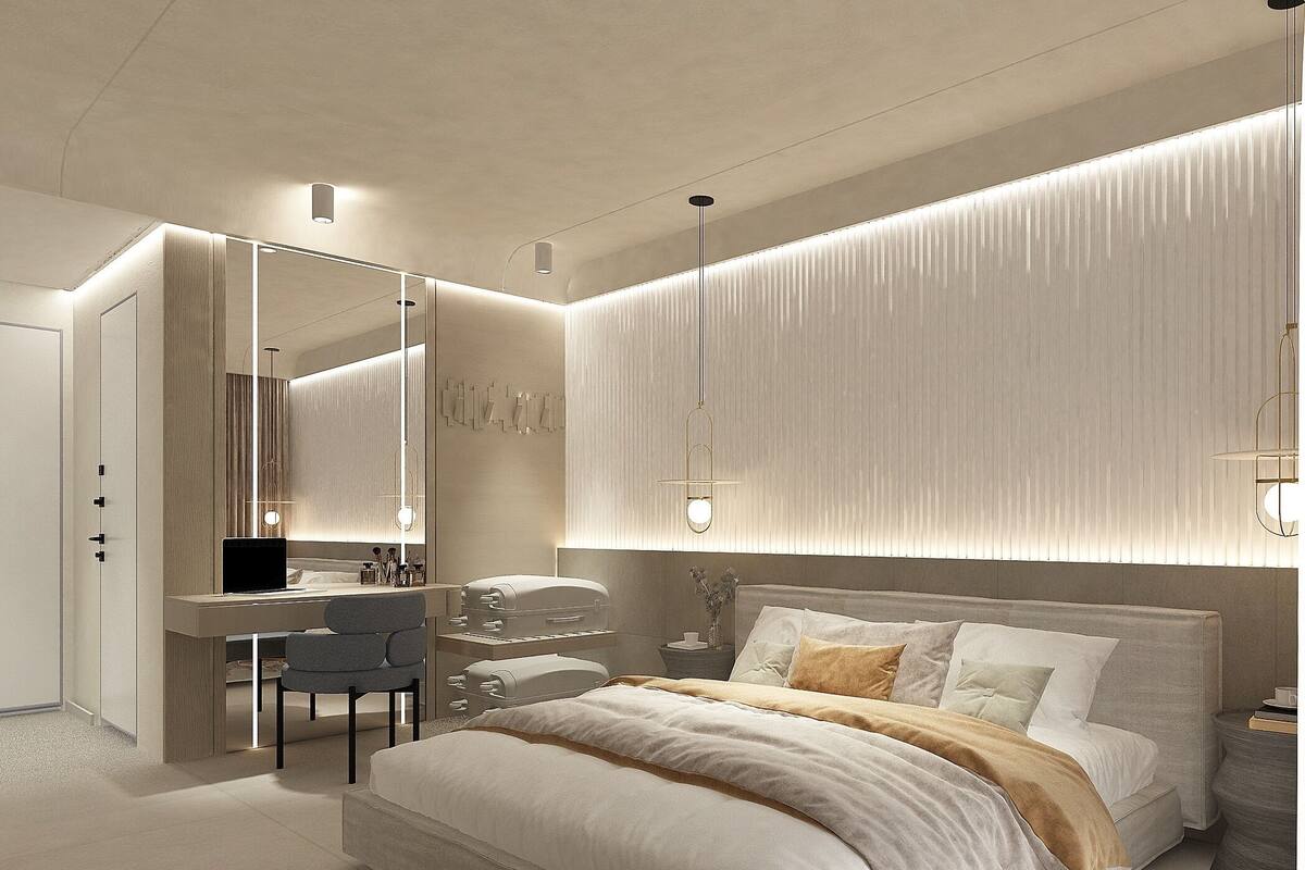 A modern bedroom with a large bed, a desk, and a mirror.