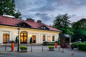 A hotel with a red-tiled roof, arched windows, and a sign reading "HOTEL".