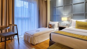 A hotel room with two beds, a desk, a chair, and a large window with curtains. - Citadines City Centre Frankfurt (Frankfurt)