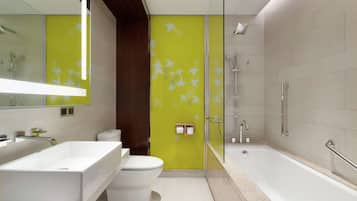 A modern bathroom with a white sink, toilet, and bathtub.