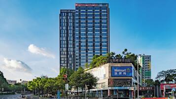 A high-rise building with a visible sign for 'Walmart' and 'King Met Arcade' on its facade.