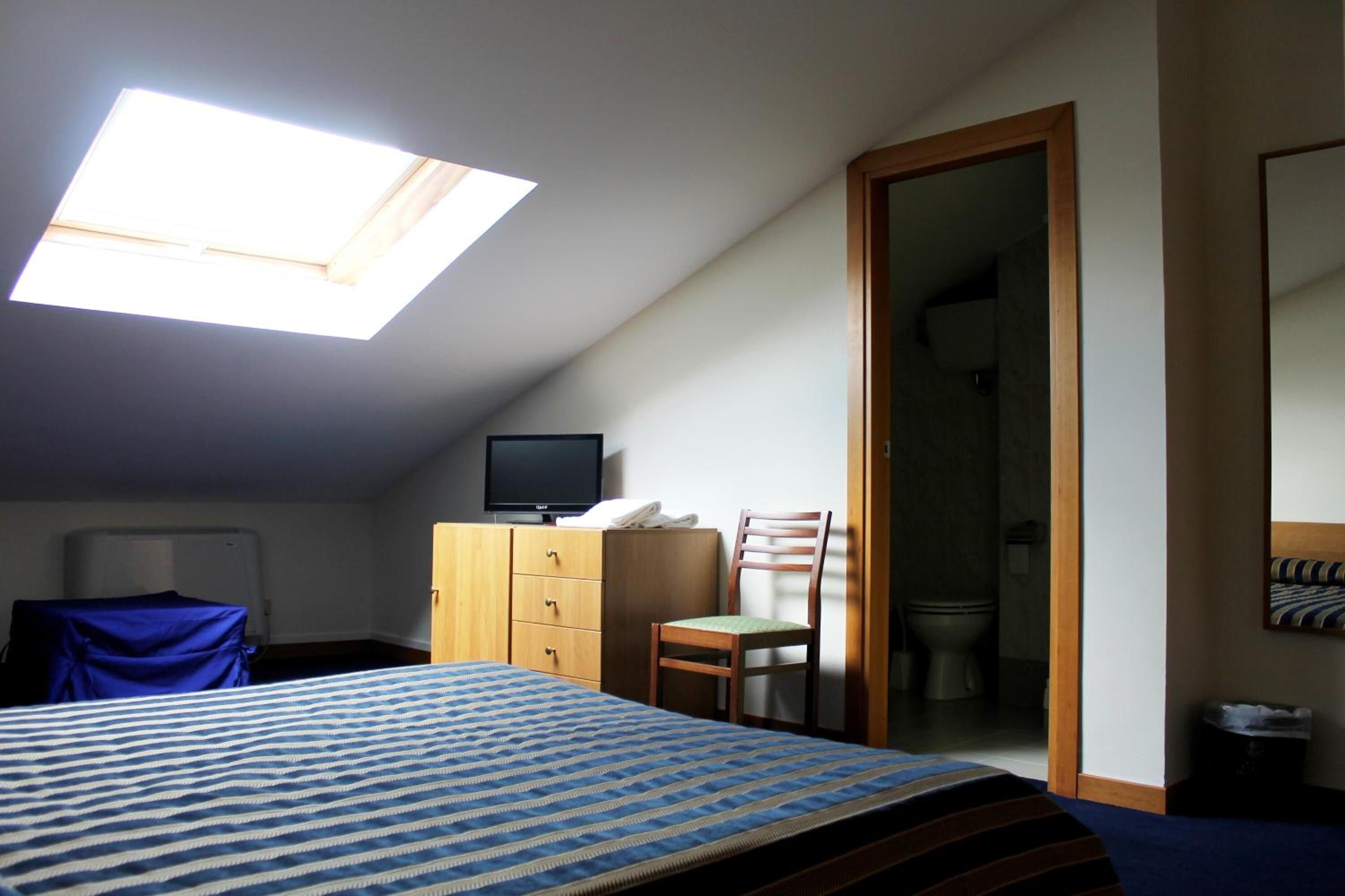 minibar, desk, blackout curtains, iron/ironing board