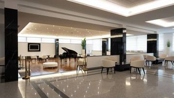 Eine großzügige Lobby mit einem Flügel, Sitzbereichen und modernem Design.